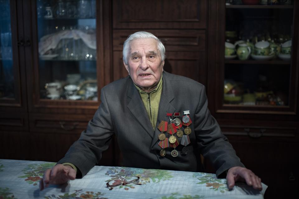 In this photo taken on Monday, Jan. 20, 2020, Yevgeny Kovalev, one of the Auschwitz concentration camp's survivors, poses for a photo during an interview with the Associated Press at his flat in Moscow, Russia. Kovalev was arrested by the Nazis as a teenager and sent to the Auschwitz death camp is still amazed 75 years later that he survived the ordeal. The 92-year-old was speaking ahead of the 75th anniversary on Monday, Jan. 27, 2020 of the camp's liberation in 1945. (AP Photo/Alexander Zemlianichenko)