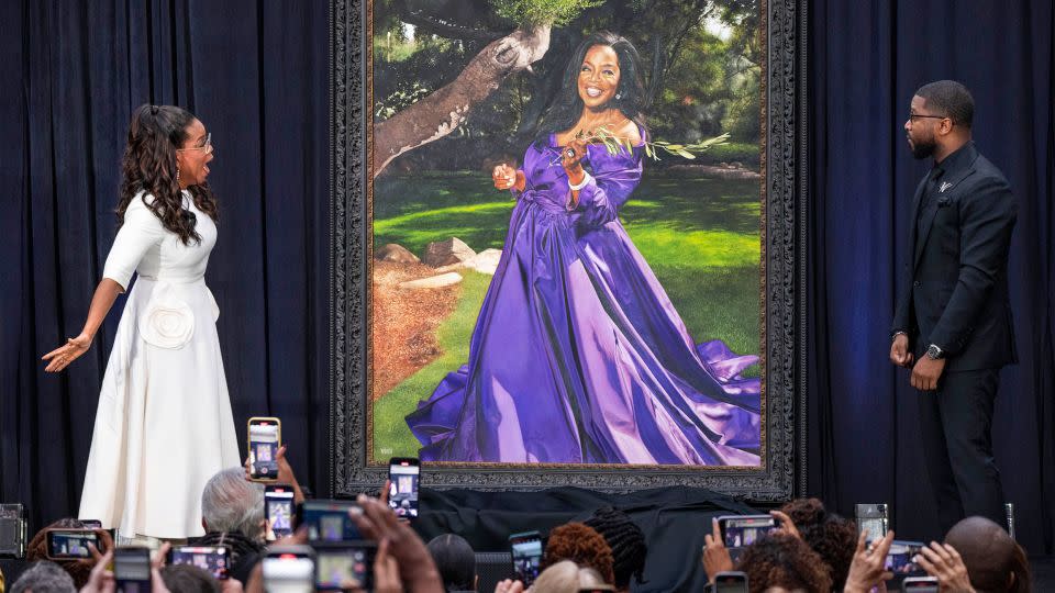 Oprah Winfrey reacts as she and artist Shawn Michael Warren, right, unveil Warren's portrait of Winfrey, Wednesday, Dec. 13, 2023, during a ceremony at the Smithsonian's National Portrait Gallery in Washington. (AP Photo/Jacquelyn Martin) - Jacquelyn Martin/AP