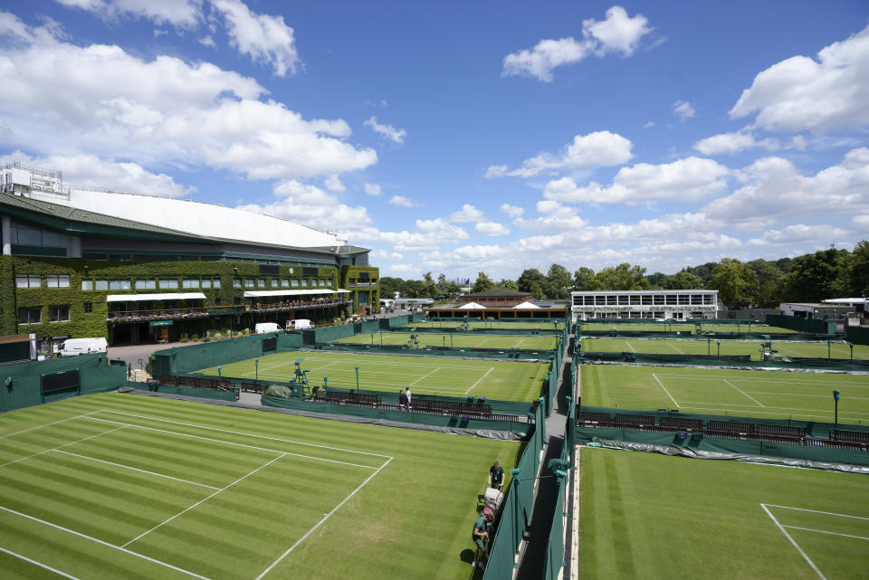 Ground staff work on the courts ahead of the Wimbledon tennis championships in London, Sunday, June 26, 2022. (AP Photo/Kirsty Wigglesworth)