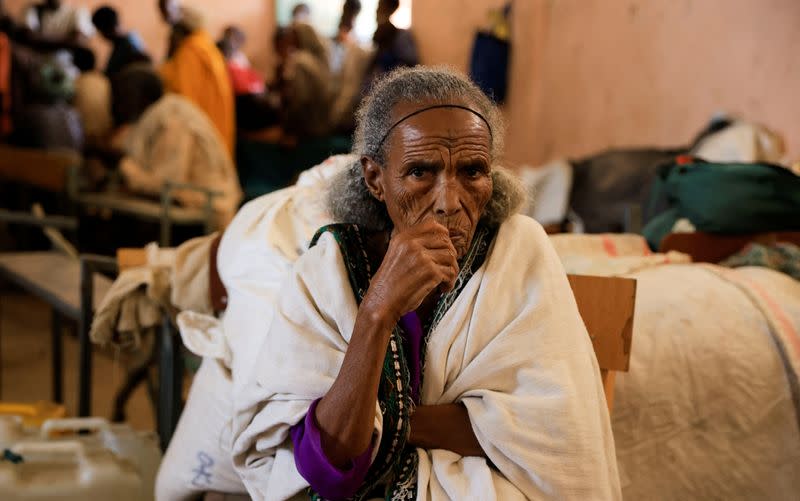 Birhan Gebremedhin, 65, displaced due to the fighting between the TPLF and ENDF sits next to her belongings at the Abi Adi camp for the Internally Displaced Persons in Abi Adi town, Tigray Region