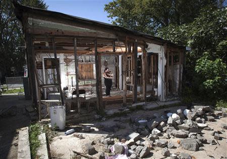 Christine Cina poses for a portrait in what is left of her house after Superstorm Sandy in the Staten Island borough of New York, September 20, 2013. REUTERS/Carlo Allegri