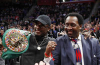 FILE- World Boxing Council's Junior Middleweight champion Tony Harrison, left, stands with former boxer Thomas "The Hitman" Hearns during the second half of an NBA basketball game between the Detroit Pistons and the Utah Jazz, Saturday, Jan. 5, 2019, in Detroit. Harrison (29-3-1, 21 KOs) is fighting Australian Tim Tszyu (21-0, 15-0 KOs) on Sunday, March 12, 2023, in Sydney for the vacant WBO 154-pound title. (AP Photo/Carlos Osorio, File)