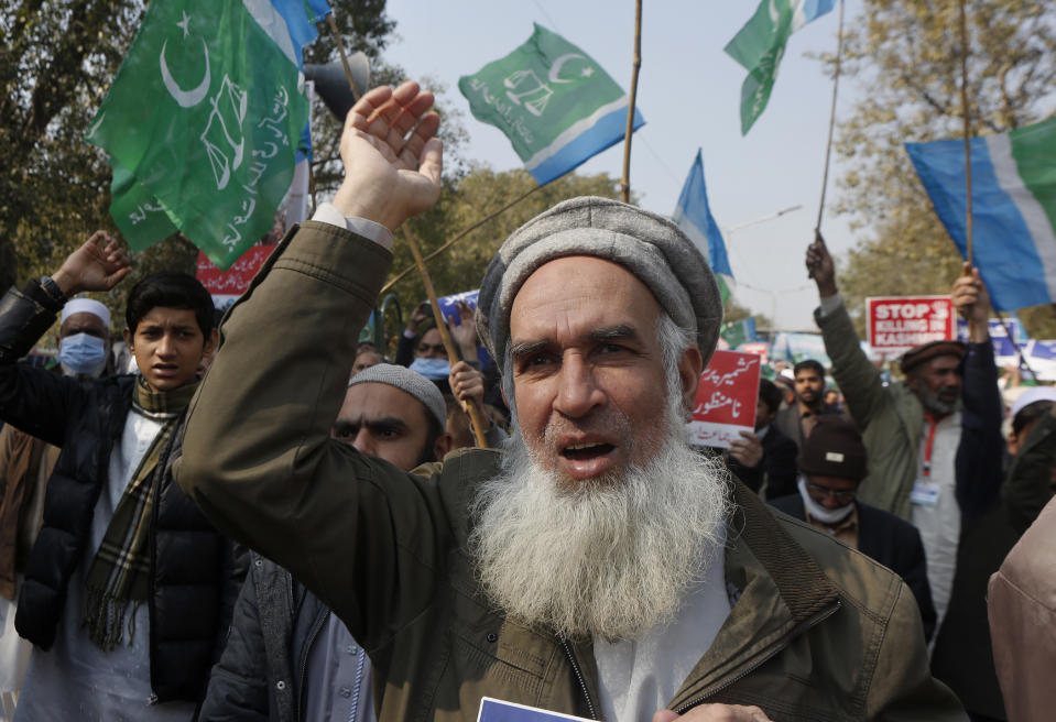 Supporters of the Pakistani religious group Jamaat-e-Islami chant anti India slogans during a rally to mark Kashmir Solidarity Day in Lahore, Pakistan, Friday, Feb. 5, 2021. Pakistan's political and military leadership on Friday marked the annual Day of Solidarity with Kashmir, vowing to continue political support for those living in the Indian-controlled part of Kashmir and for a solution to the disputed region's status in accordance with U.N. resolutions. (AP Photo/K.M. Chaudary)