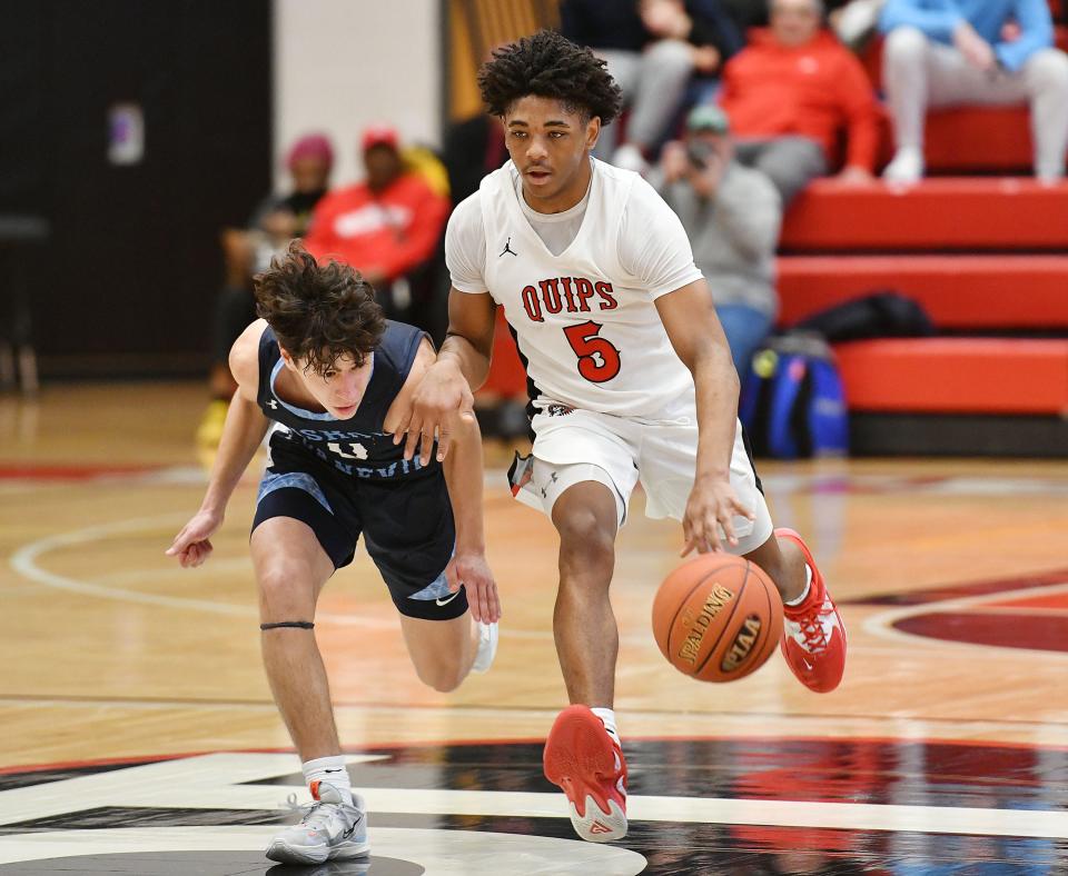 Aliquippa's Quentin Goode brings the ball down the court as Bishop Canevin's Geno DeFrank presses during Saturday's PIAA Class 2A quarterfinal game at Peters Township High School.