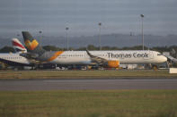 A Thomas Cook plane on the tarmac at Gatwick Airport in Sussex, England Monday Sept. 23, 2019. British tour company Thomas Cook collapsed early Monday after failing to secure emergency funding, leaving tens of thousands of vacationers stranded abroad. (Steve Parsons/PA via AP)