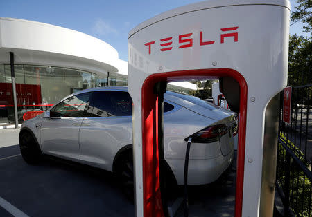 FILE PHOTO: A Tesla Model X vehicle is charged by a supercharger outside a Tesla electric car dealership in Sydney, Australia, May 31, 2017. REUTERS/Jason Reed/File Photo