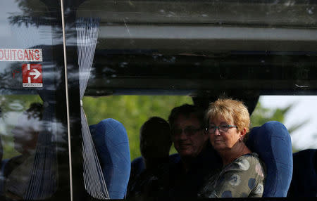 Some of the 36 Dutch tourists are seen on a bus ahead of their flight out of South Africa on Tuesday after they were robbed at gunpoint on Sunday in a brazen heist while traveling from Johannesburg's main international airport to their hotel, officials said, in Johanneburg, South Africa, September 26, 2017. REUTERS/Siphiwe Sibeko