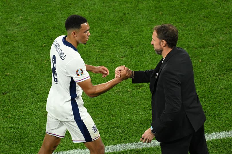 Trent Alexander-Arnold of England shakes hands with Gareth Southgate after being substituted at Euro 2024