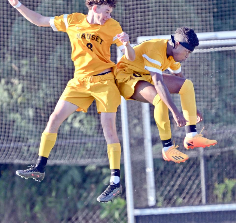 Omari Perry (right) celebrates with Nauset teammate Devin Farrell after scoring a goal against Nantucket.