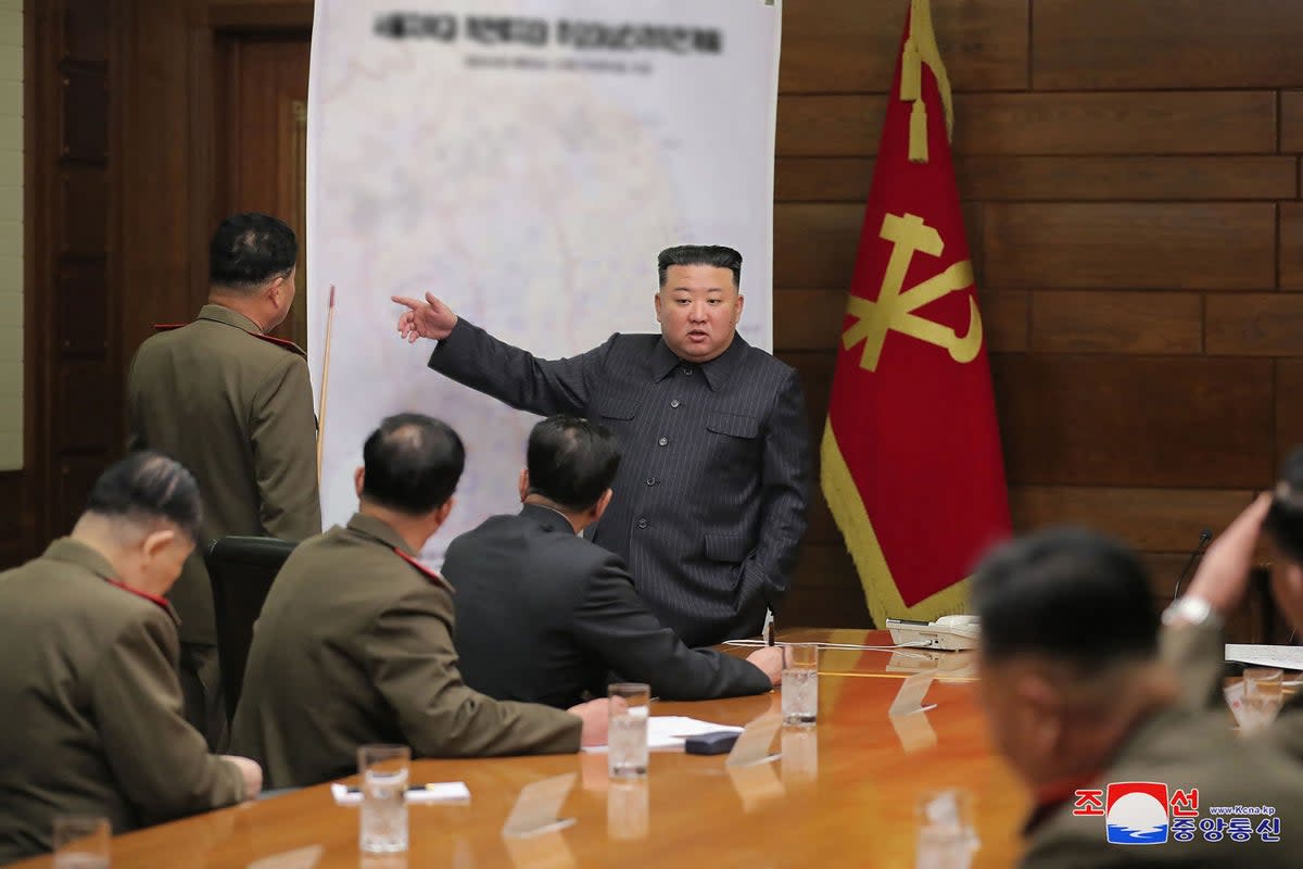 North Korean leader Kim Jong-un (C) gesturing in front of a map while attending the 6th Enlarged Meeting of the 8th Central Military Commission of the Workers' Party of Korea (WPK)  (KCNA VIA KNS/AFP via Getty Image)