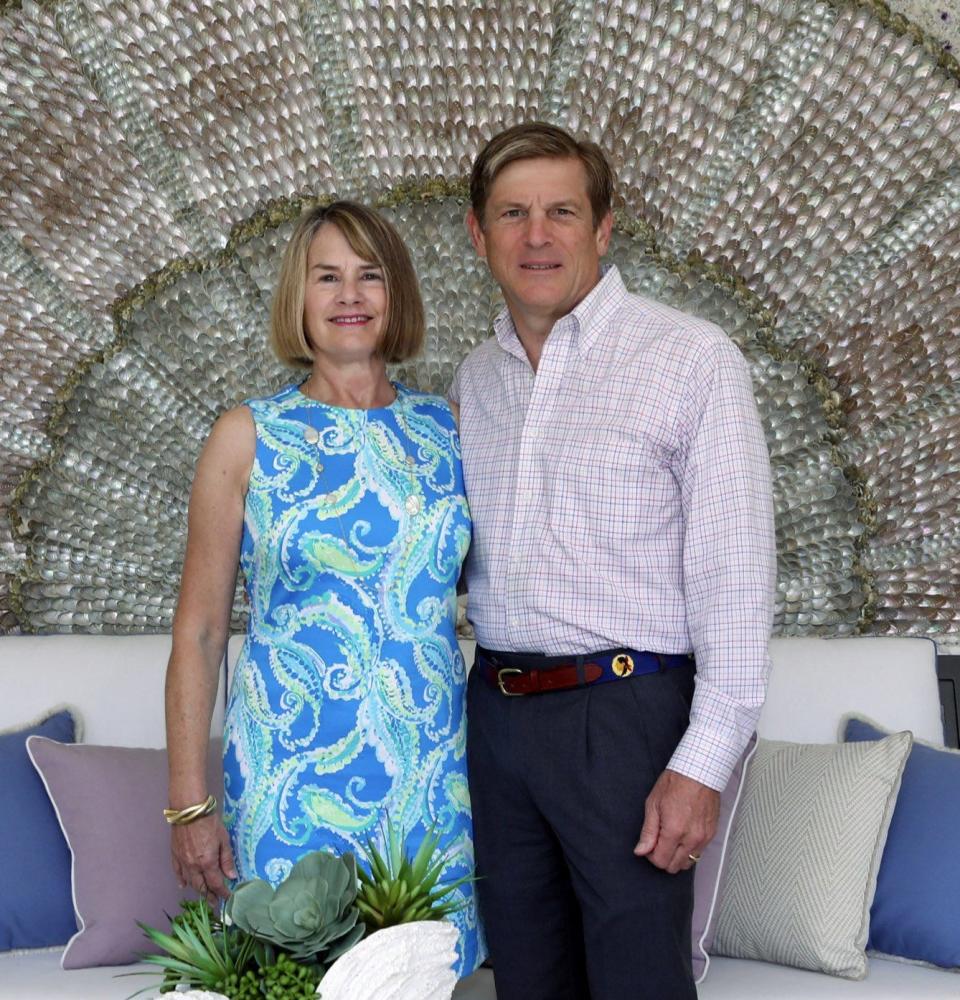 Leigh and John Middleton, who owns the Philadelphia Phillies, stand by a wall near the west pool in their home in Palm Beach in 2019, the year the estate earned a landscaping award from the Preservation Foundation of Palm Beach.