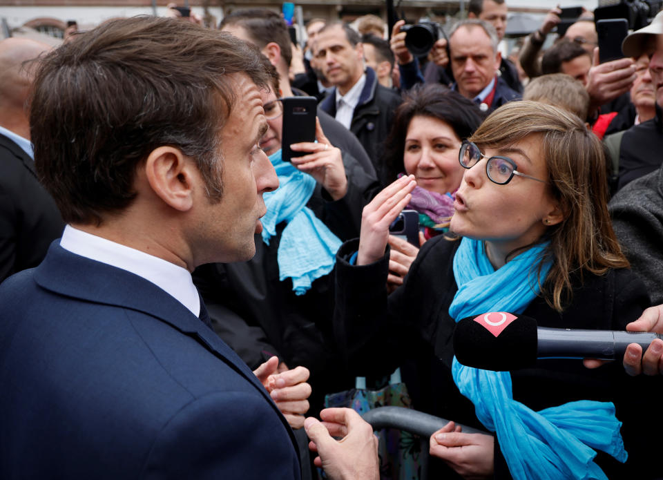 French President Emmanuel Macron argues with a person opposed to the pension reform, in Selestat, eastern France, Wednesday, April 19, 2023. French President Emmanuel Macron said Monday April 17, 2023 that he heard people's anger over raising the retirement age from 62 to 64, but insisted that it was needed to keep the pension system afloat as the population ages. Emmanuel Macron is trying to repair the damage done to his public image and politics by forcing the pension plan through parliament last month. (Ludovic Marin, Pool via AP)