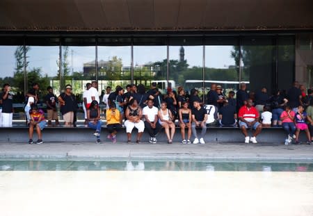 People are seen in front of a museum during a heat wave in Washington