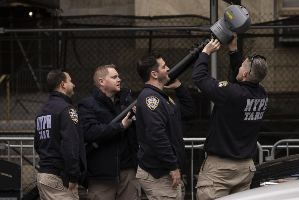 New York Police personnel set up a surveillance camera outside Manhattan Criminal Court in New York, Friday, March 31, 2023. (AP Photo/Yuki Iwamura)