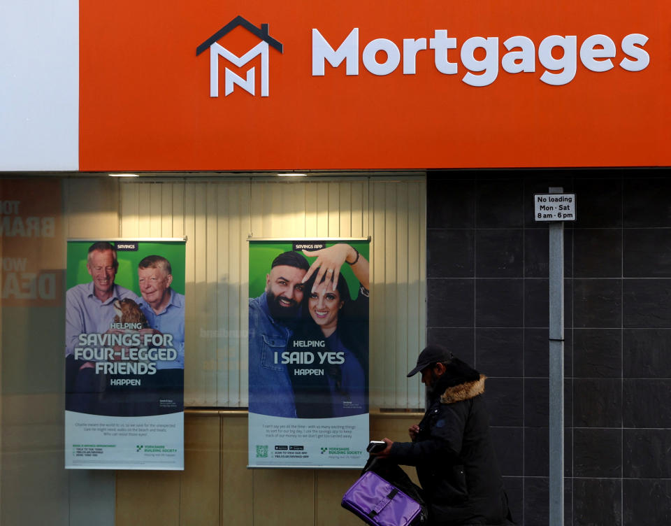 A shopper walk past a mortgage advertisement displayed in a window in Sunderland