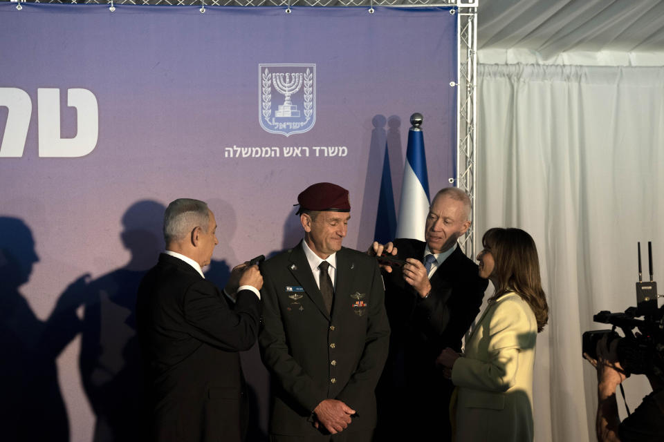 Sharon Halevi, right, watches as Israeli Prime Minister Benjamin Netanyahu, left, and Defense Minister Yoav Gallant, second right, promote her husband, the new Israel Defense Forces Chief of Staff Herzi Halevi to the rank of Lieutenant-General in Jerusalem, Monday, Jan. 16, 2023. (AP Photo/ Maya Alleruzzo, Pool)