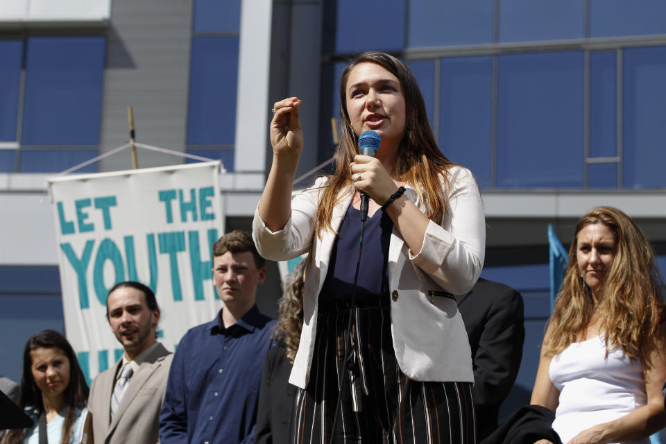 FILE - In this June 4, 2019, file photo, Kelsey Rose Juliana, of Eugene, Ore, speaks at a rally for a group of young people who filed an environmental lawsuit against the U.S. government in Portland, Ore. Oregon is on the precipice of becoming the second state after California to adopt a cap-and-trade program, a market-based approach to lowering the greenhouse gas emissions behind global warming. (AP Photo/Steve Dipaola, File)