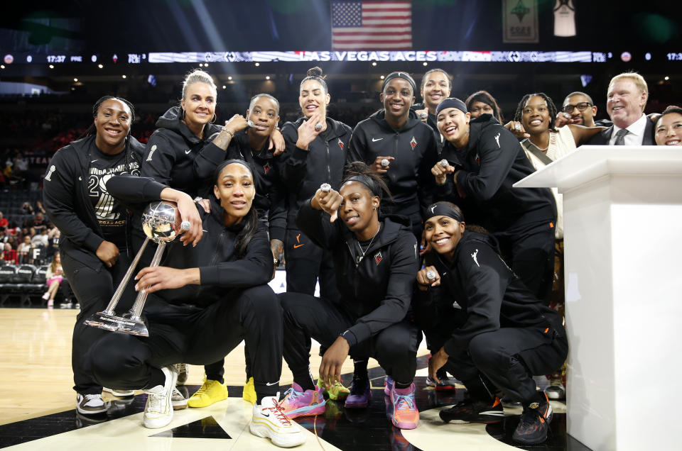 LAS VEGAS, NEVADA - MAY 27: Members of the Las Vegas Aces pose with head coach Becky Hammon (2nd-L) and Las Vegas Raiders owner and general partner and Las Vegas Aces owner Mark Davis (2nd- R) during a WNBA 2022 championship ring ceremony prior to the Aces' game against the Los Angeles Sparks at Michelob ULTRA Arena on May 27, 2023 in Las Vegas, Nevada.  NOTE TO USER: User expressly acknowledges and agrees that by downloading and/or using this photograph, user accepts the terms and conditions of the Getty Images License Agreement.  (Photo by Steve Marcus/Getty Images)