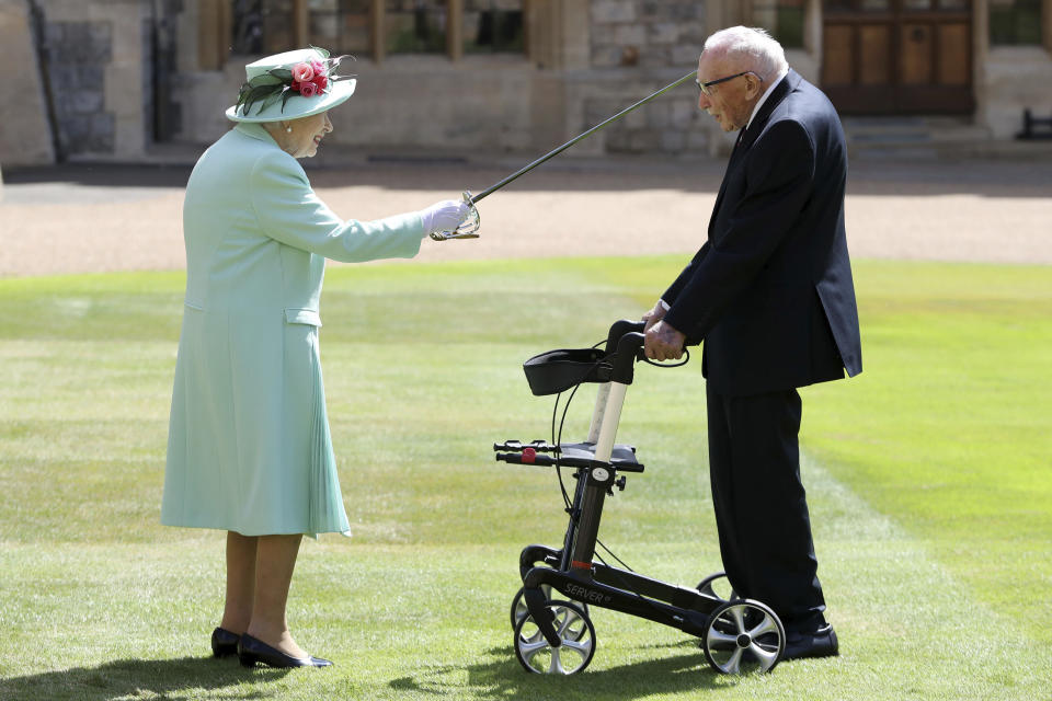 Captain Sir Thomas Moore arrives to receive his knighthood from Britain's Queen Elizabeth, during a ceremony at Windsor Castle in Windsor, England, Friday, July 17, 2020. Captain Sir Tom raised almost £33 million for health service charities by walking laps of his Bedfordshire garden. (Chris Jackson/Pool Photo via AP)