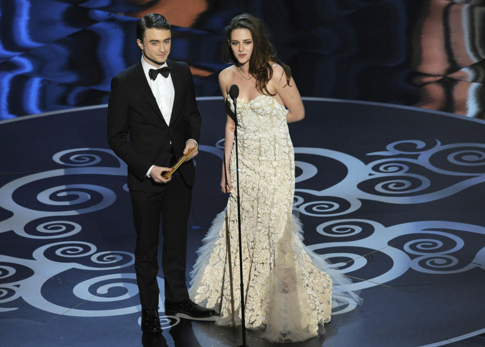 Actors Daniel Radcliffe, left, and Kristen Stewart present an award during the Oscars at the Dolby Theatre on Sunday Feb. 24, 2013, in Los Angeles. (Photo by Chris Pizzello/Invision/AP)