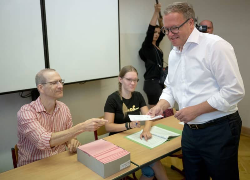 Mario Voigt chairman of the CDU in Thuringia and his party's lead candidate,  receives his ballot paper for the Thuringia state election at the polling station. The state election in Thuringia takes place on 01 September. Hannes P. Albert/dpa