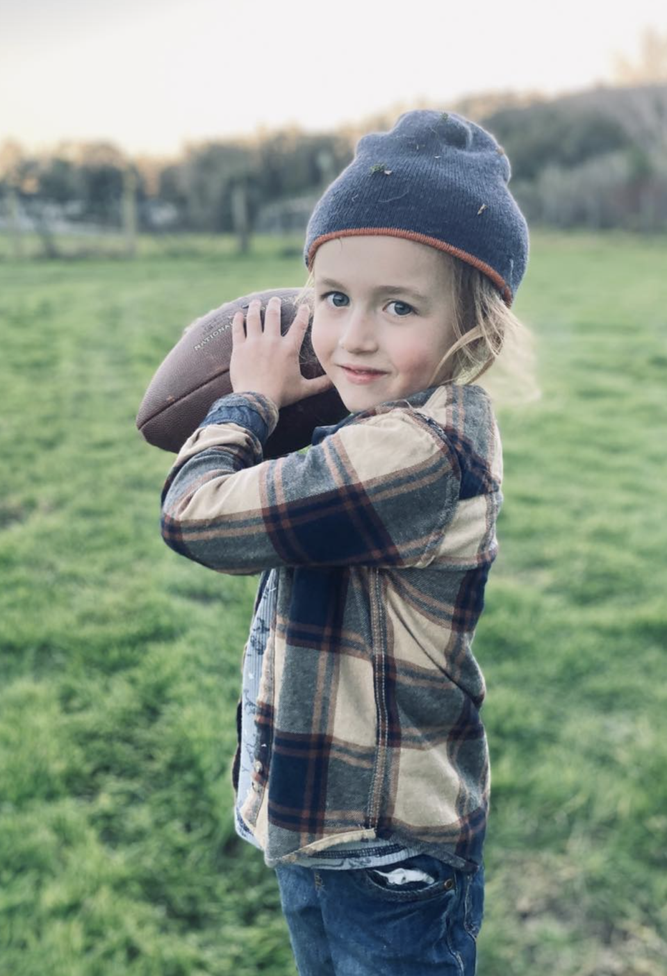 Jack Trexler is pictured enjoying some football. The 5-year-old survived a mountain lion attack when his mother charged the big cat.