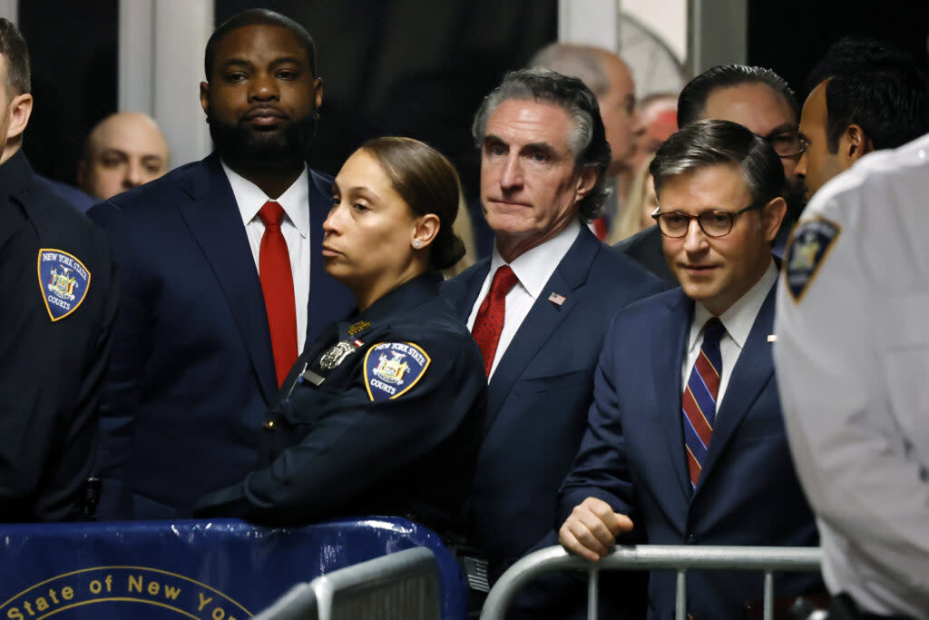 Representative Byron Donalds of Florida., North Dakota Gov. Doug Burgum and House Speaker Mike Johnson of Louisiana watch as former President Donald Trump walks towards the courtroom for his hush money trial at Manhattan Criminal Court on May 14, 2024, in New York City.