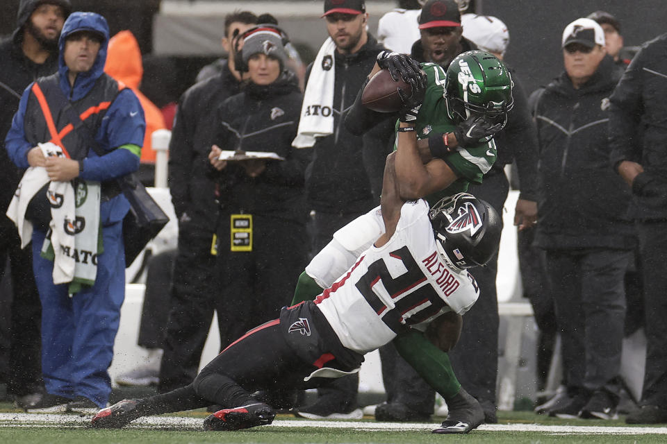 New York Jets wide receiver Garrett Wilson (17) comes down with a pass against Atlanta Falcons cornerback Dee Alford (20) during the third quarter of an NFL football game, Sunday, Dec. 3, 2023, in East Rutherford, N.J. (AP Photo/Adam Hunger)