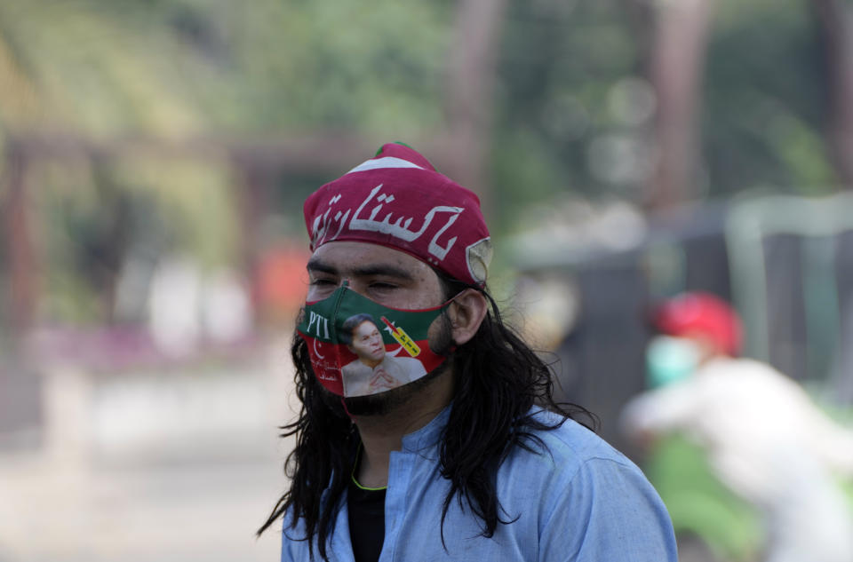 A supporter of Pakistan's former Prime Minister Imran Khan gestures during a protest against the arrest of his leader, in Lahore, Pakistan, Wednesday, May 10, 2023. Khan can be held for eight days, a court ruled Wednesday, a day after the popular opposition leader was dragged from a courtroom and arrested on corruption charges, deepening the country's political turmoil. (AP Photo/K.M. Chaudary)