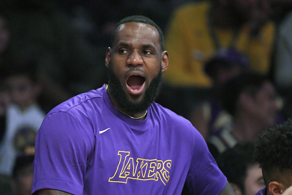 Los Angeles Lakers forward LeBron James yawns as he sits on the bench during the second half of a preseason NBA basketball game against the Golden State Warriors, Monday, Oct. 14, 2019, in Los Angeles. The Lakers won 104-98. (AP Photo/Mark J. Terrill)