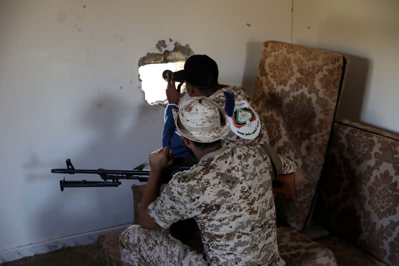 FILE PHOTO: Members of the Libyan internationally recognised government forces take their positions in Ain Zara