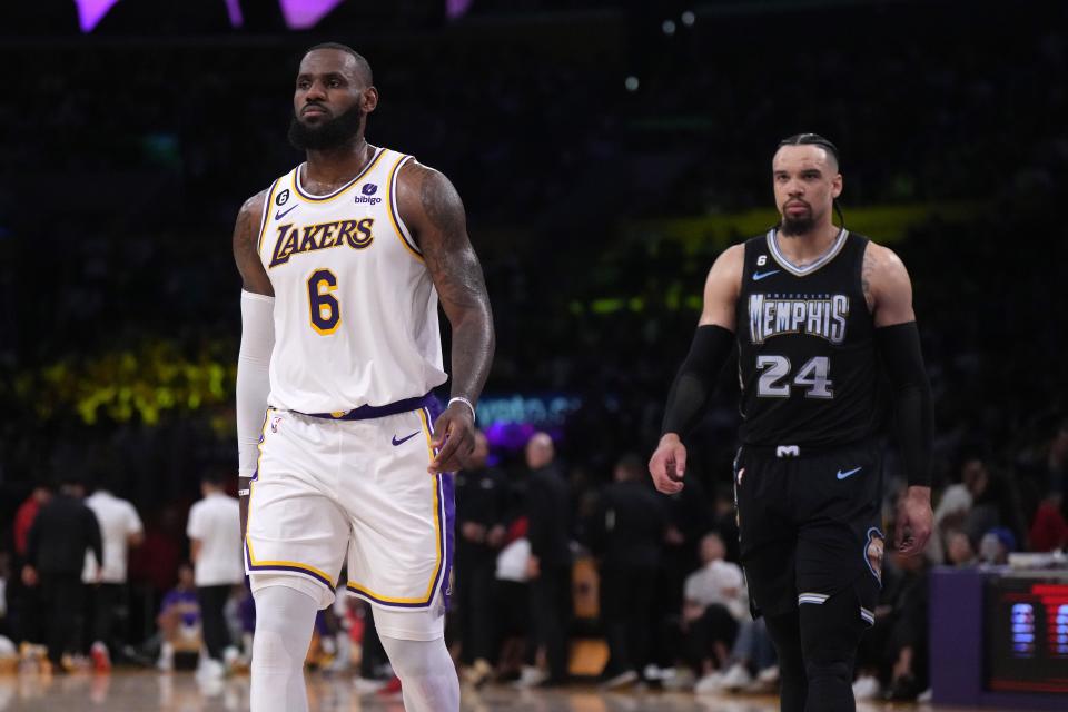Los Angeles Lakers forward LeBron James (6) and Memphis Grizzlies forward Dillon Brooks (24) react in the second quarter during game three of the 2023 NBA playoffs at Crypto.com Arena.