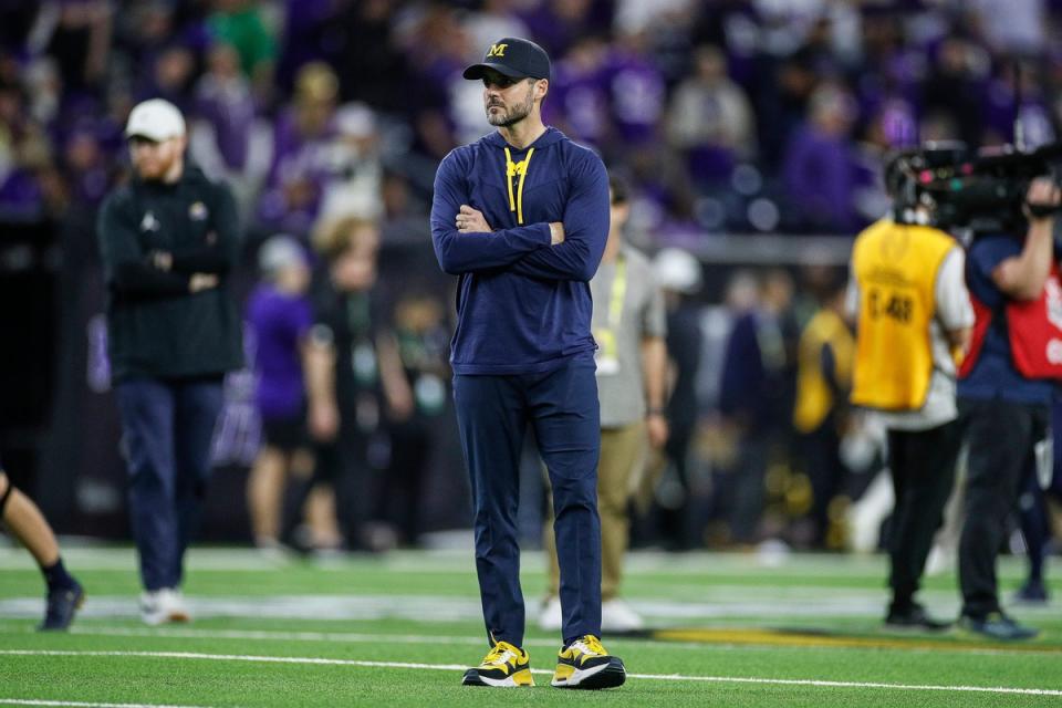 Michigan defensive coordinator Jesse Minter watches warm ups before the national championship game at NRG Stadium in Houston on Monday, Jan. 8, 2024.