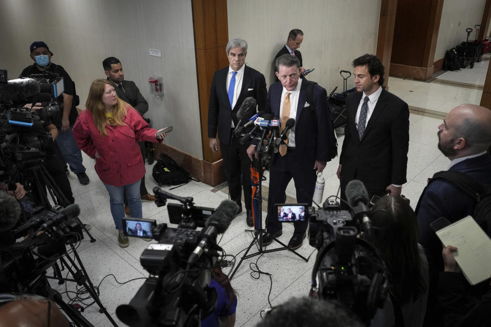 Dan Cogdell, rear center, a defense attorney for Texas Attorney General Ken Paxton, talks to reporters with fellow defense attorneys Philip Hilder, center left, and Anthony Osso, Jr., center right, after Paxton appeared in the 185th District Court for a hearing in his securities fraud case, Friday, Feb. 16, 2024, at the Harris County criminal courthouse in Houston. A judge on Friday rejected Paxton’s attempts to throw out felony securities fraud charges that have shadowed the Republican for nearly a decade. (Jon Shapley/Houston Chronicle via AP)