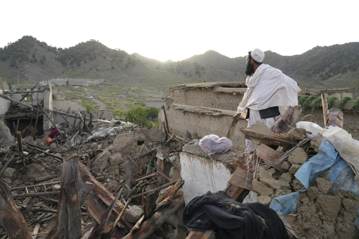 A man stands among destruction after an earthquake in Gayan village, in Paktika province, Afghanistan, Thursday, June 23, 2022. A powerful earthquake struck a rugged, mountainous region of eastern Afghanistan early Wednesday, flattening stone and mud-brick homes in the country's deadliest quake in two decades, the state-run news agency reported. (AP Photo/Ebrahim Nooroozi)