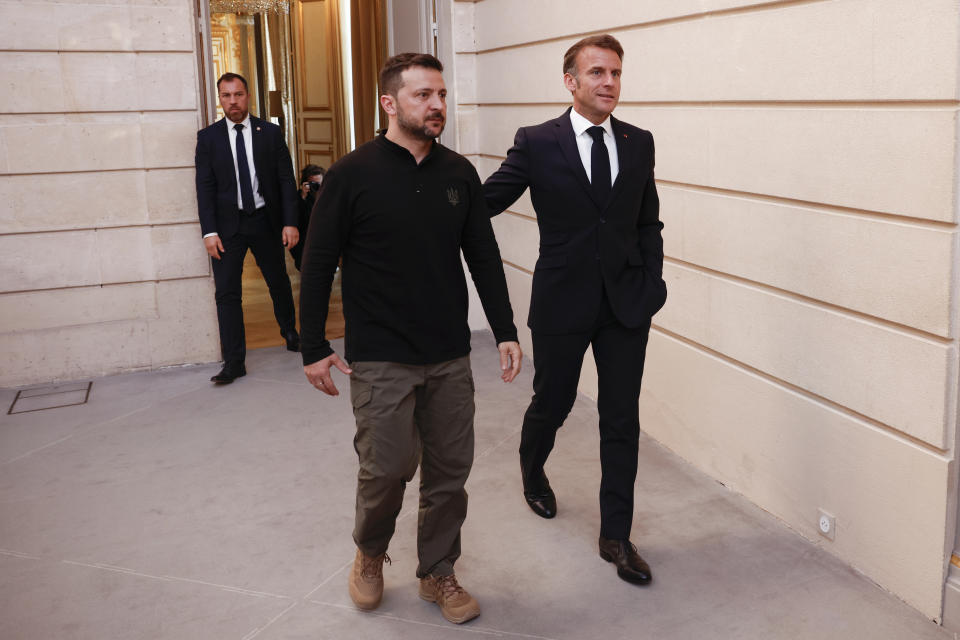 French President Emmanuel Macron, right, and Ukrainian President Volodymyr Zelenskyy arrive to a joint press conference, Friday, June 7, 2024 at the Elysee Palace in Paris. U.S. President Joe Biden was due to meet with Ukrainian President Volodymyr Zelenskyy in Paris on Friday as Kyiv's army endures its hardest days of fighting since the early weeks of the war with Russia and prepares for what officials say could be a tough summer ahead. (Yoan Valat, Pool via AP)