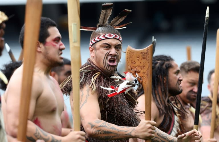 Maori men perform a haka as the casket of late rugby legend Jonah Lomu is carried onto Eden Park during a memorial service on November 30, 2015