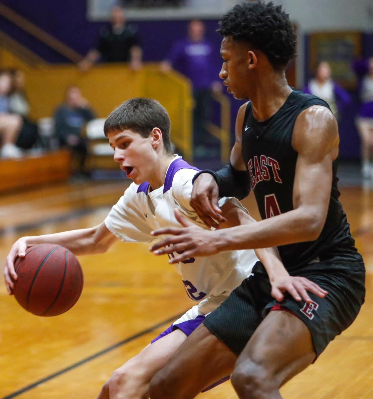 Clarksville's Kellen Howard (12) moves down the court while being defended by Memphis East's Alijah Curry (4) in the TSSAA Class 4A Sectional between the Clarksville Wildcats and East Memphis Mustangs at Clarksville High School in Clarksville, Tenn., on Monday, March 7, 2022. 