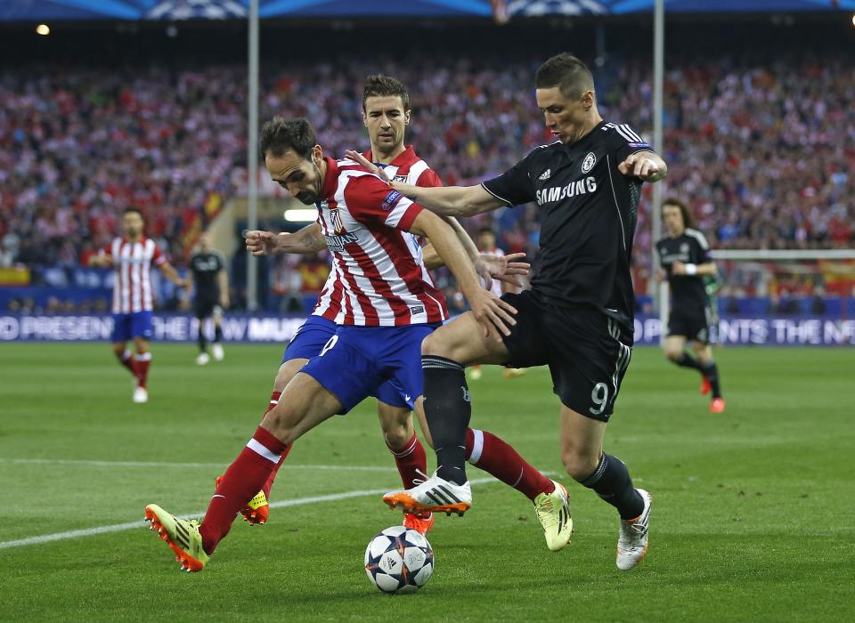 Juanfran, del Atlético de Madrid, a la izquierda, disputa el balón con Fernando Torres, del Chelsea, durante el partido de ida de las semifinales de la Liga de Campeones, en el estadio Vicente Calderón, en Madrid, España, el martes 22 de abril de 2014. El partido terminó empatado 0-0. (AP Foto/Andrés Kudacki)