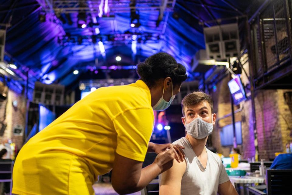 Nathaniel McVeigh receives a dose the Pfizer/BioNTech Covid-19 vaccine at Heaven nightclub in central London in August 2021 (Dominic Lipinski/PA) (PA Wire)