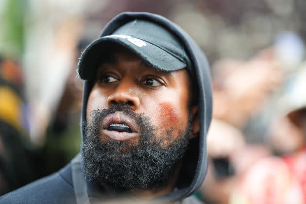 Kanye West is seen wearing a Balenciaga boxing mouthguard, outside Givenchy, during Paris Fashion Week. (Photo: Edward Berthelot via Getty Images)