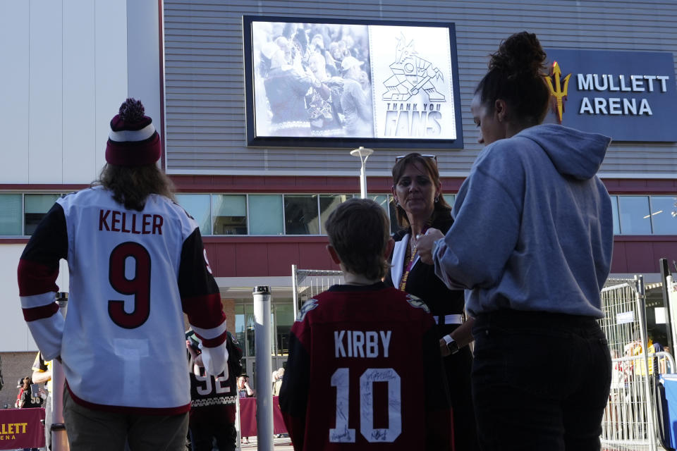 Arizona Coyotes fans start to gather for what is expected to be the franchise's final NHL hockey game in the Phoenix area, against the Edmonton Oilers, at the main entrance to Mullett Arena on Wednesday, April 17, 2024, in Tempe, Ariz. (AP Photo/Ross D. Franklin)