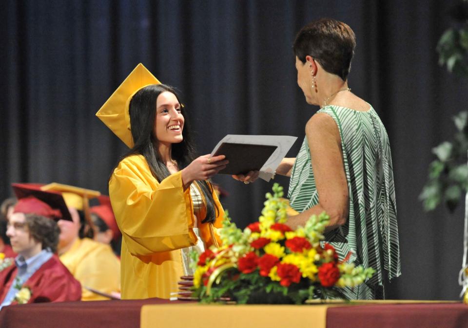 Camille Sabag, left, is all smiles as she receives her diploma from Weymouth Evening High School Administrator Michele Prendergast during the Weymouth Evening High School graduation Monday, May 22, 2023.