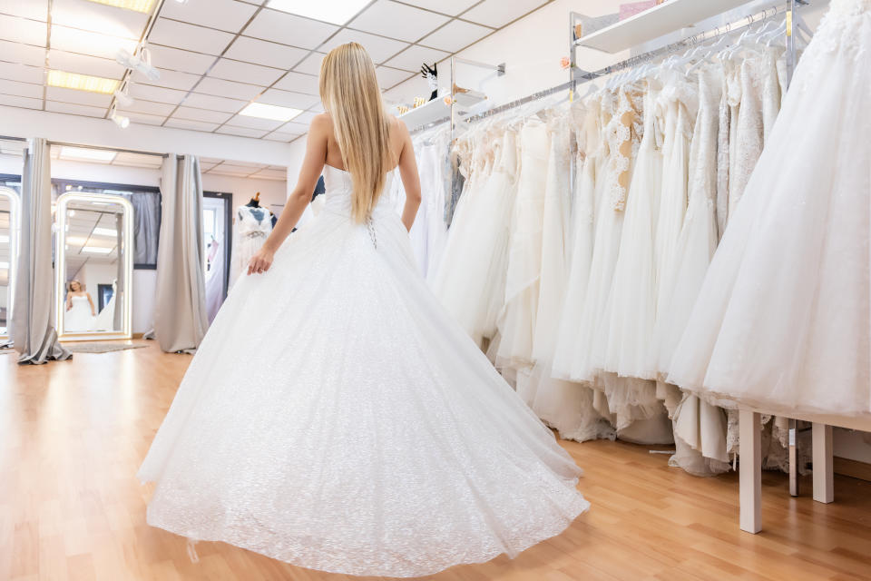 bride in bridal shop in haute couture wedding dress.