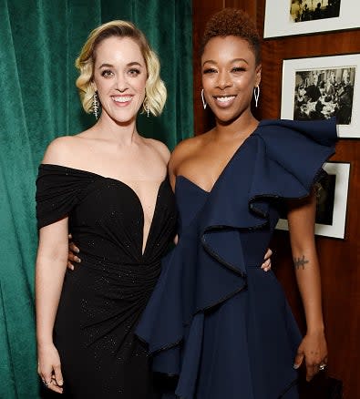 Samira Wiley and Lauren Morelli at a celebrity event, both smiling and posing. Samira is in a one-shoulder ruffled dress, Lauren in an off-shoulder gown