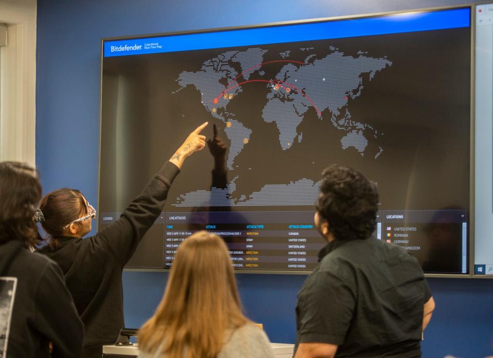 Hopkinton High School students look at a cyberthreat real-time map in the Cyber Range at the Center For Cybersecurity Education at MassBay Community College, April 3, 2024.