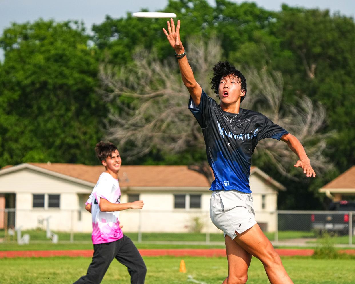 LASA's Solomon Moon, leaping for a catch during a Vertikills practice, plays football and ultimate frisbee. He said ultimate frisbee is more popular at his school than football, and the participation numbers back that up.