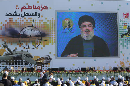 Lebanon's Hezbollah leader Sayyed Hassan Nasrallah speaks via a screen during a rally marking the 11th anniversary of the end of Hezbollah's 2006 war with Israel, in the southern village of Khiam, Lebanon August 13, 2017. REUTERS/Aziz Taher