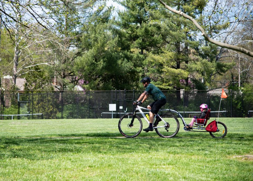 A biker rides on a park path on Thursday, April 2, 2020 at the West Hills park in West Knoxville, TN. On Tuesday, March 31st, 2020 and Wednesday, April 1st, 2020, Parks and Recreation employees roped off playgrounds in city parks in reaction to the coronavirus pandemic.