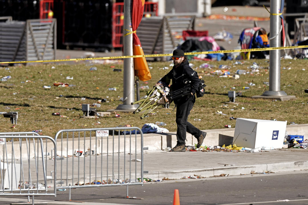 A person collects items left behind at the scene of the shooting outside Union Station.